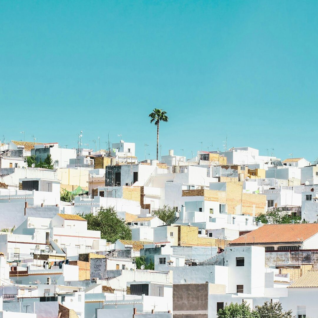 white and brown concrete houses under blue sky during daytime